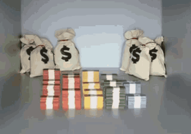 a bunch of bags with dollar signs on them