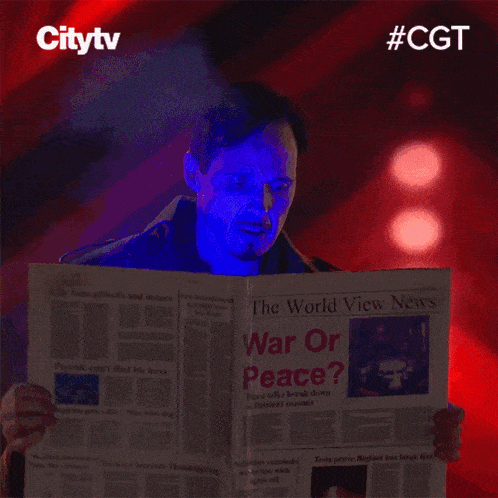 a man is reading a newspaper which says war or peace