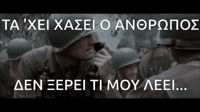 a man in a helmet is talking into a microphone in front of a crowd of soldiers