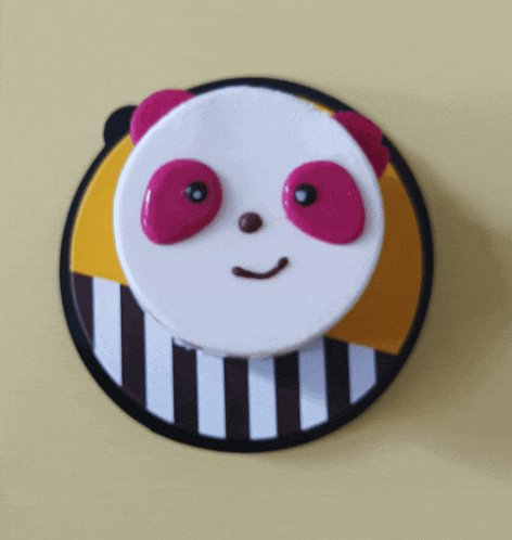 a cake with a panda face on top of a striped plate