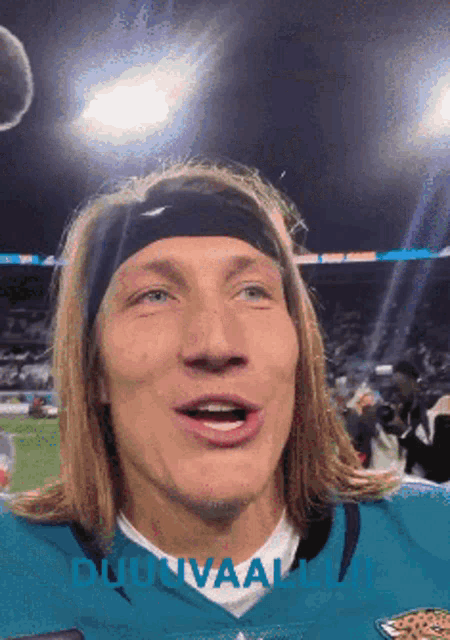 a man wearing a headband and a jaguars jersey looks at the camera