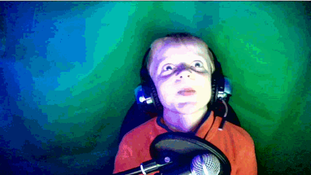a young boy wearing headphones and a microphone