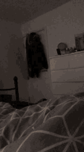 a dog laying on a bed with a striped blanket