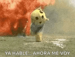 a stuffed animal is standing in front of an explosion and says `` ya habla ... ahora me voy '' .