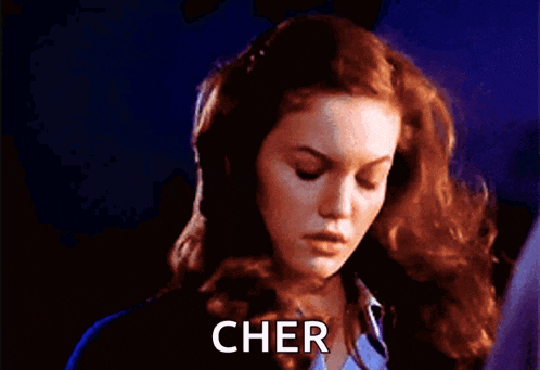 a close up of a woman 's face with cher written on the bottom