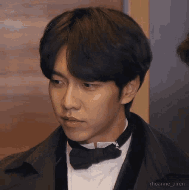a close up of a man in a tuxedo with a bow tie