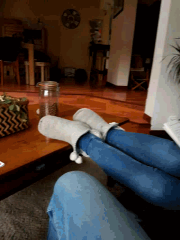 a person wearing a pair of slippers sitting on a table