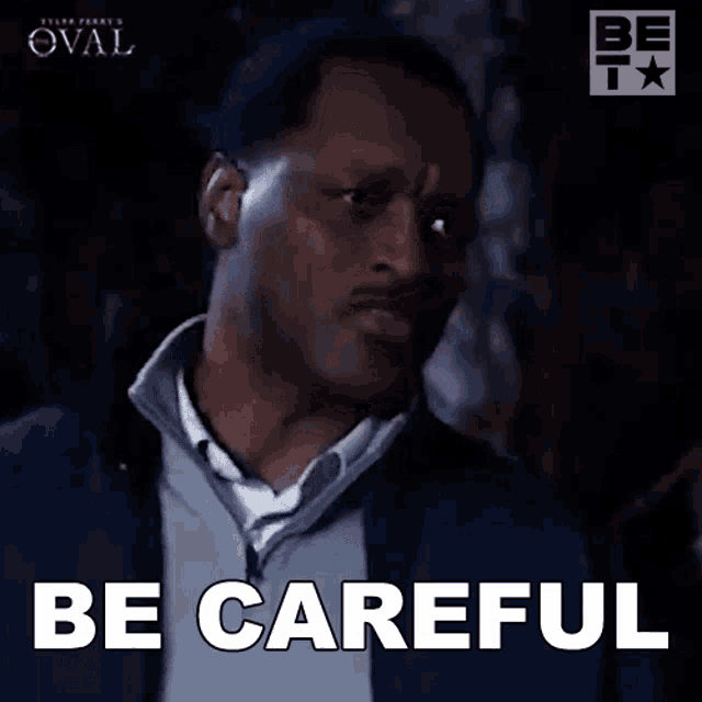 a man in a suit is making a face and saying be careful