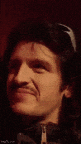 a close up of a man 's face with a mustache making a funny face .