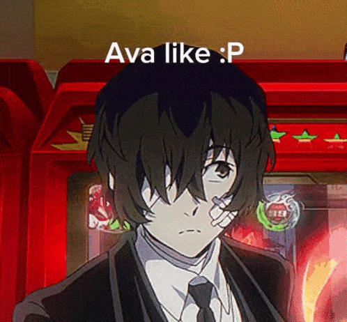 a man in a suit and tie with a bandage on his nose is standing in front of an arcade machine and says ava like p
