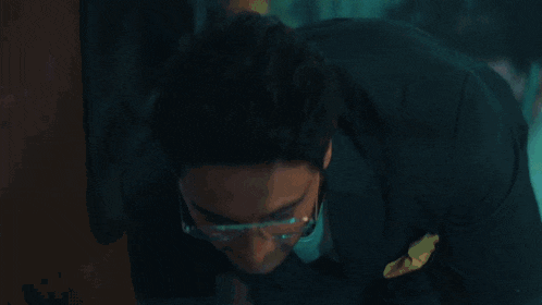 a man wearing glasses is looking at the camera