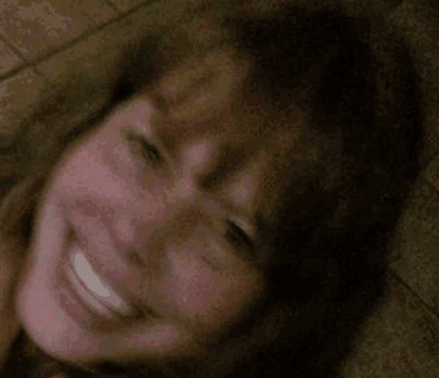 a close up of a woman 's face with a blurred background