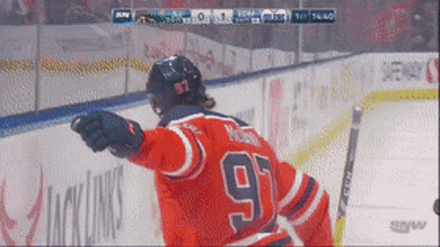 a hockey player wearing a jersey with the number 97 on it