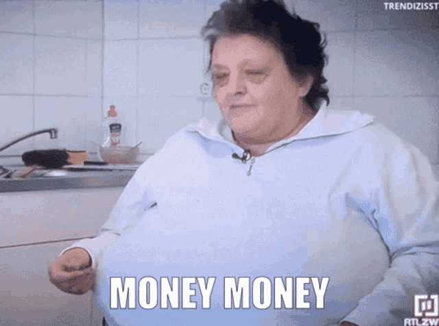 a woman says money money in front of a kitchen