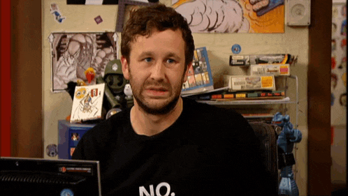 a man sitting in front of a computer wearing a no shirt