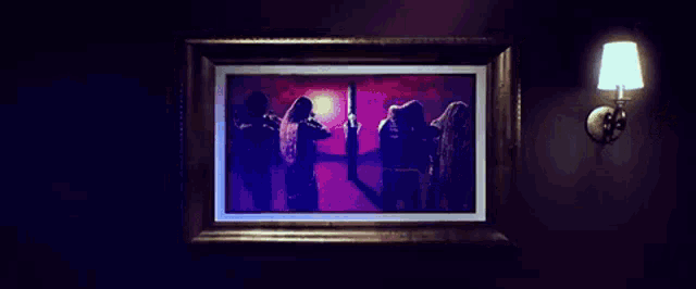 a picture of three women standing next to each other in a dark room .