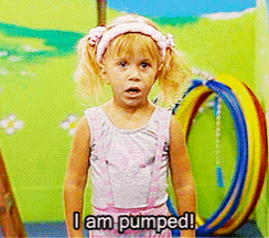 a little girl says i am pumped while standing in front of a hula hoop