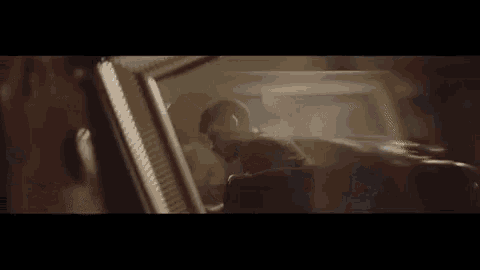 a man is sitting in the back seat of a car playing a keyboard .