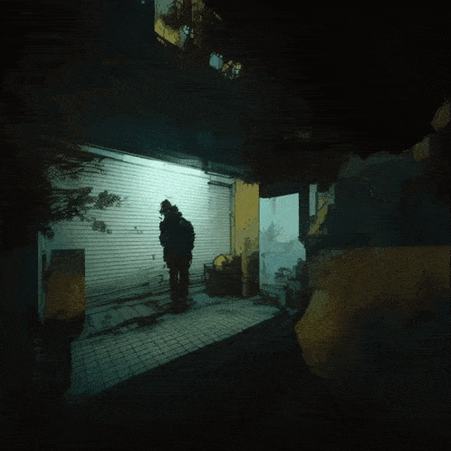 a person standing in a dark room with a sign that says ' scuba ' on it