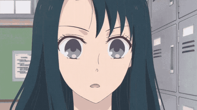 a close up of a girl 's face in front of a wall with lockers