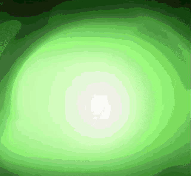 a green light is shining on a black background