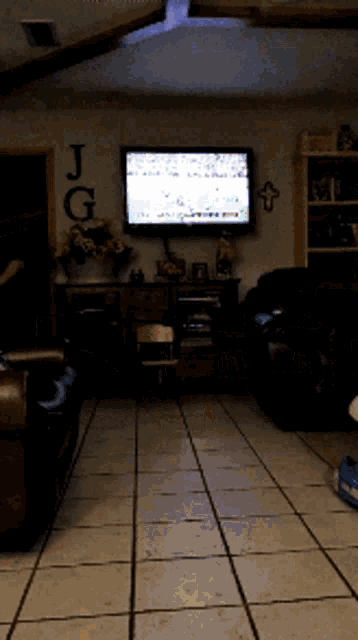 a living room with a j and g written on the wall