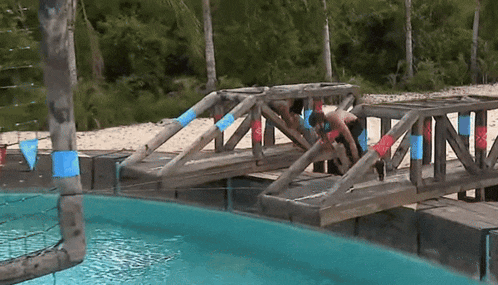 a wooden bridge over a body of water with the letter n on the side