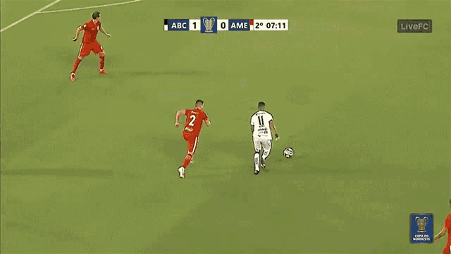 a soccer goalie is laying on the ground in front of an ad for cademy