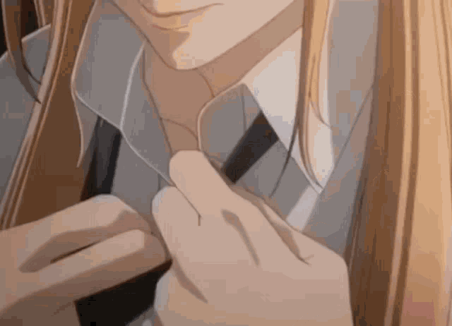 a close up of a person adjusting a tie .