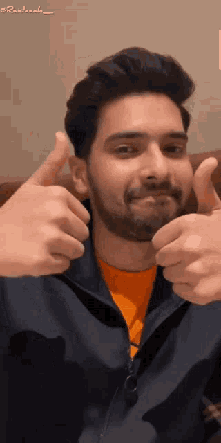 a man with a beard giving a thumbs up sign