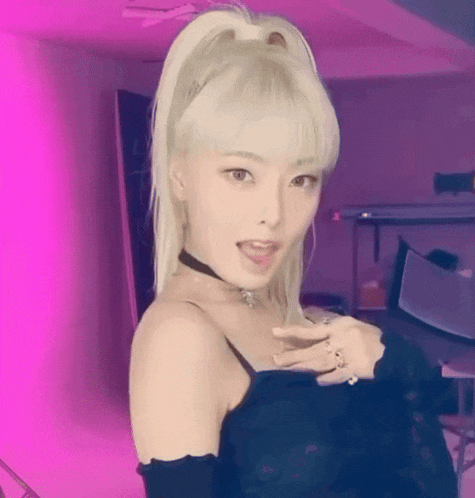 a woman with blonde hair is wearing a choker and a black dress .