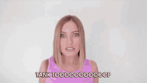 a woman in a pink tank top is making a funny face and saying `` tank too ! ''
