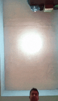a man is standing in front of a ceiling with a light on it