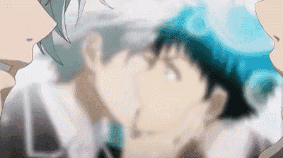 a couple of anime characters are kissing each other in a blurry photo .
