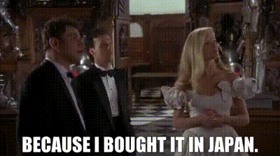 a man in a tuxedo stands next to a woman in a white dress and says because i brought it in japan