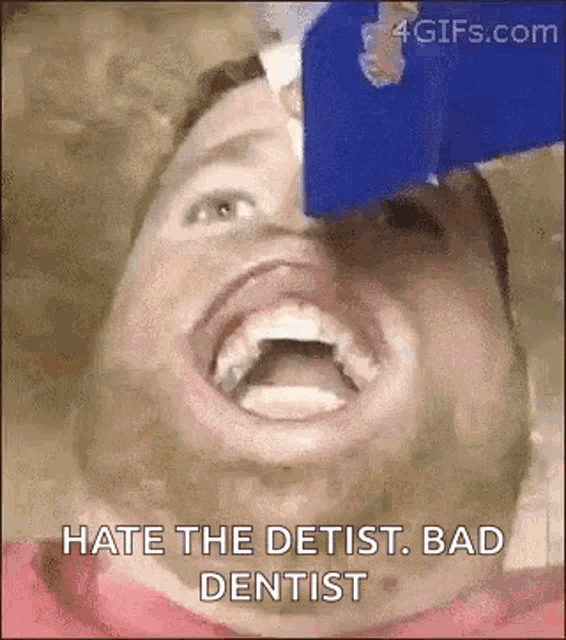 a man is getting his teeth checked by a dentist and is laughing .