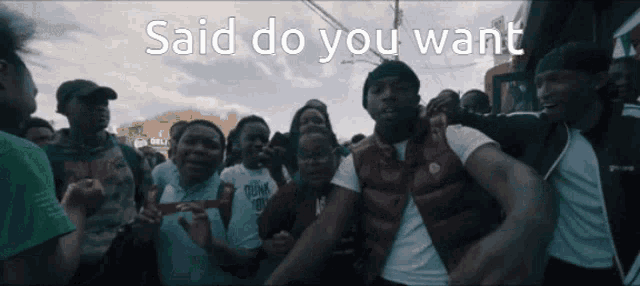 a group of people are standing in a crowd with the words " said do you want " on the bottom