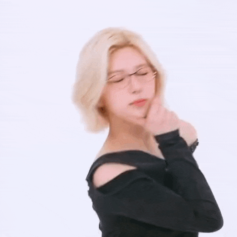 a woman wearing glasses is making a funny face .