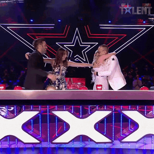 a man and a woman are hugging in front of a sign that says talent