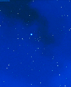 a hand reaches out towards a star in the night sky
