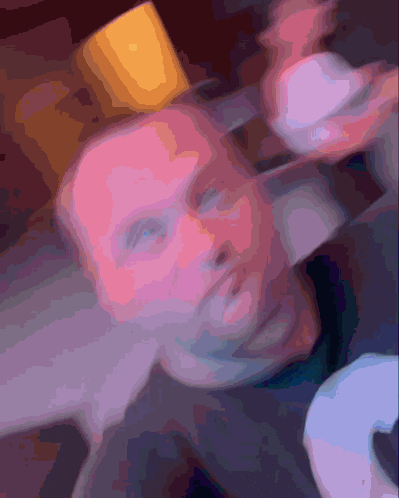 a blurry picture of a person 's face with a yellow object on top of it