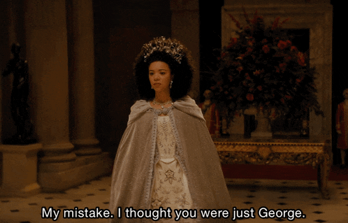a woman wearing a cape and a tiara says my mistake i thought you were just george