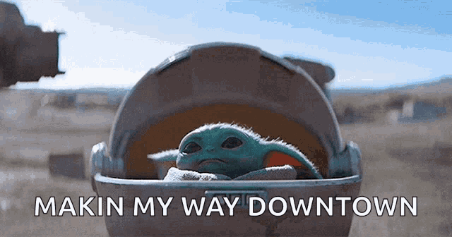 a baby yoda is sitting in a stroller with the words makin my way downtown written on the bottom .