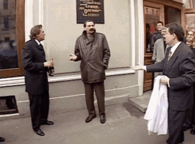 a group of men are standing in front of a building with a sign on it that says ' o'connell '