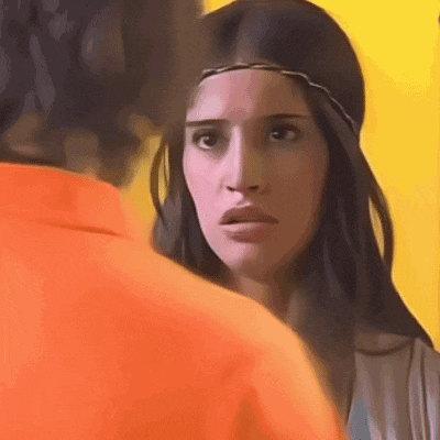 a woman with a headband on her head looks at a man in an orange shirt