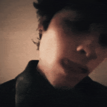 a close up of a person 's face with a shadow on it