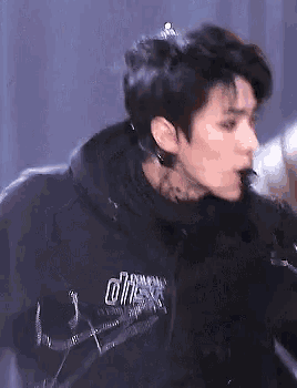 a close up of a man wearing a black hoodie that says ' a ' on it