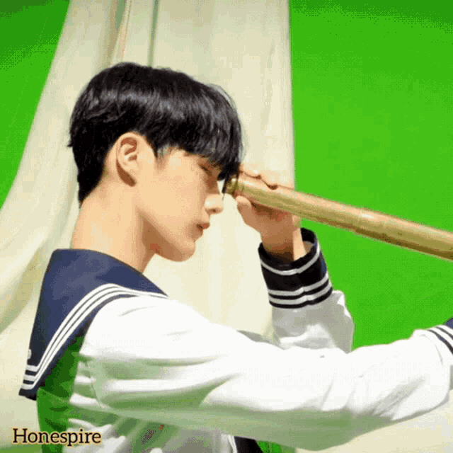 a boy in a sailor uniform looks through a telescope with the word hone spire on the bottom right