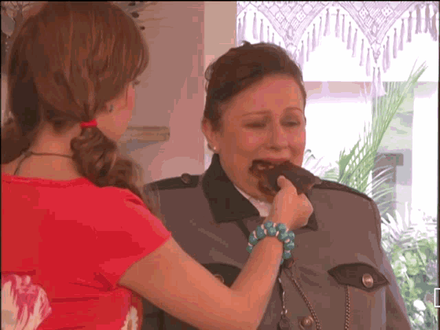 a woman in a police uniform eating a chocolate bar
