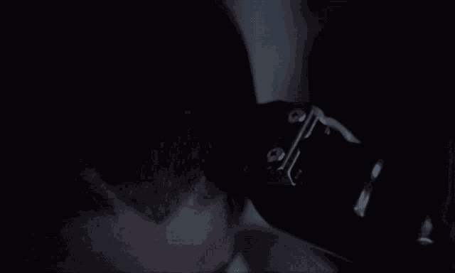 a close up of a person 's head with a black object in the foreground